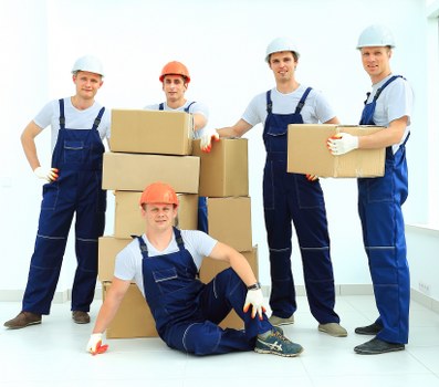 Trained removals staff using equipment to protect furniture