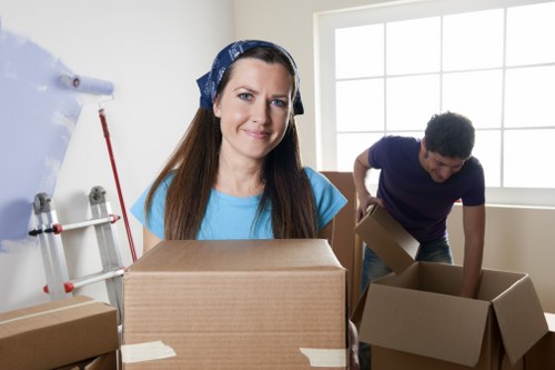 Removal crew wearing PPE while carrying household items